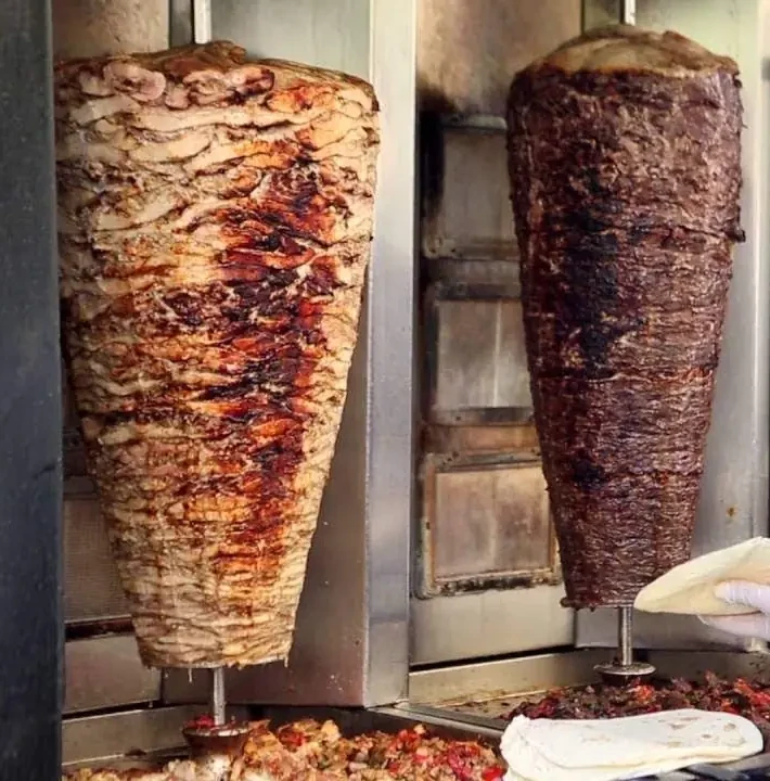Chicken and beef shawarma roasting on the spit
